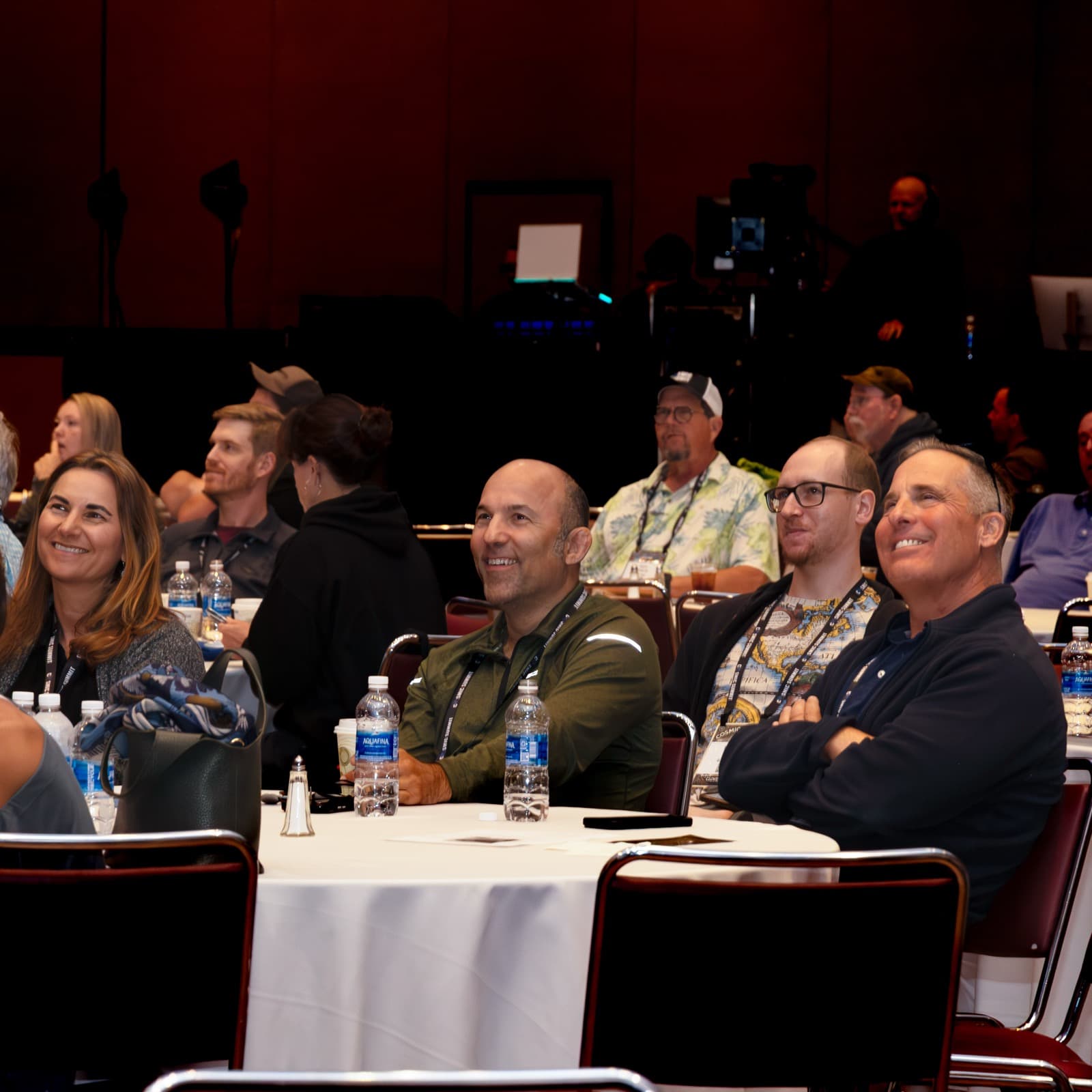People in the Cosmic Summit audience smiling during a talk