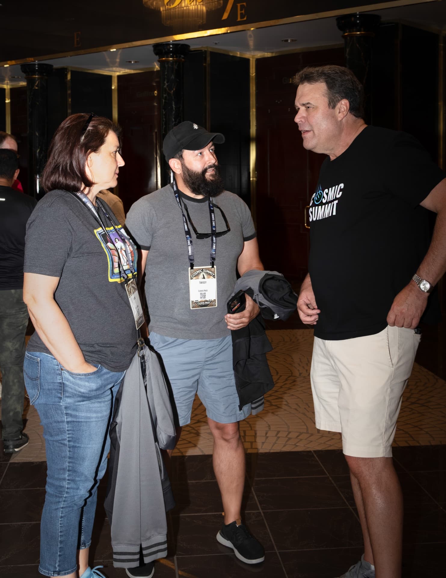 Two Cosmic Summit attendees in animated conversation between sessions
