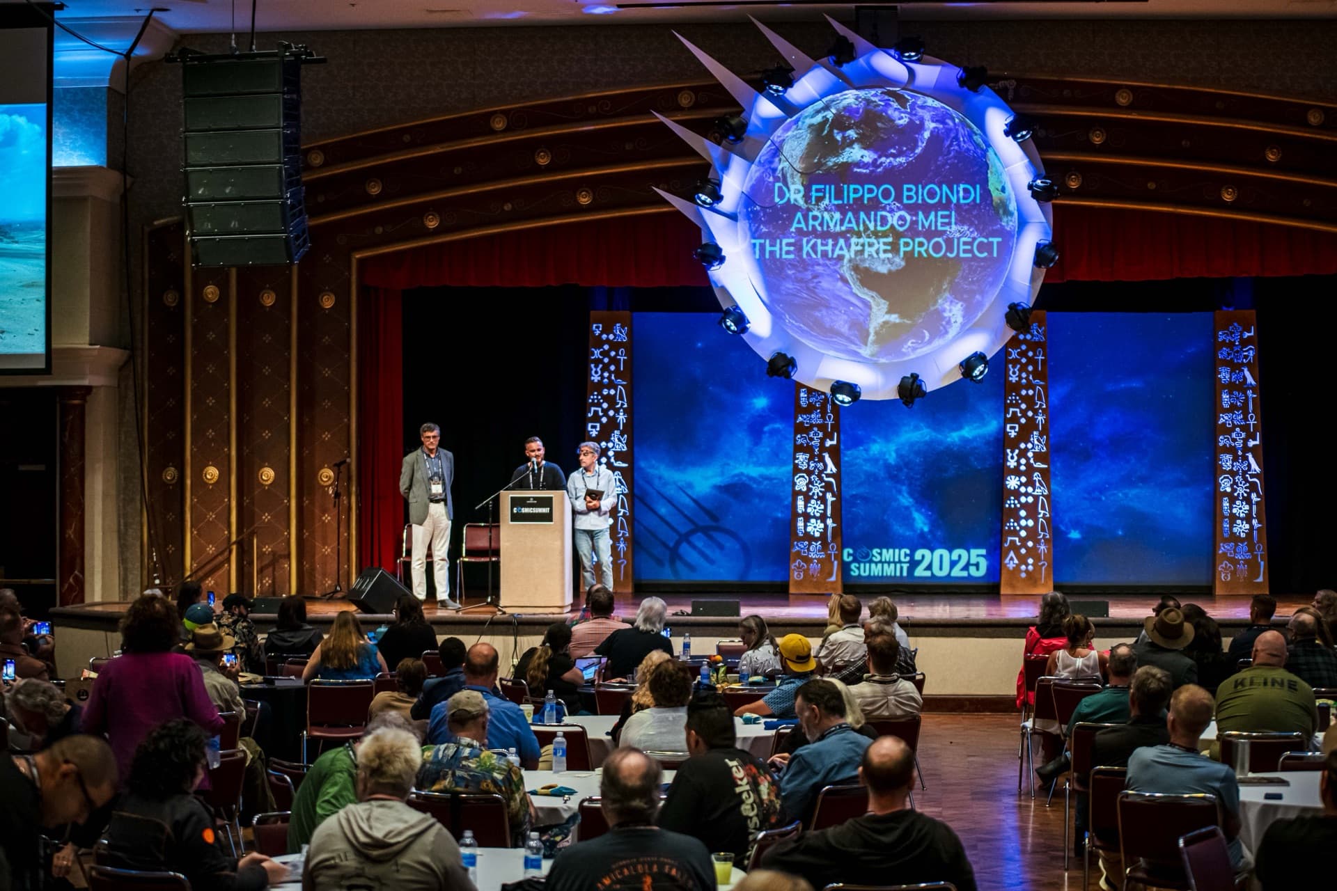 Cosmic Summit main stage with audience filling the room