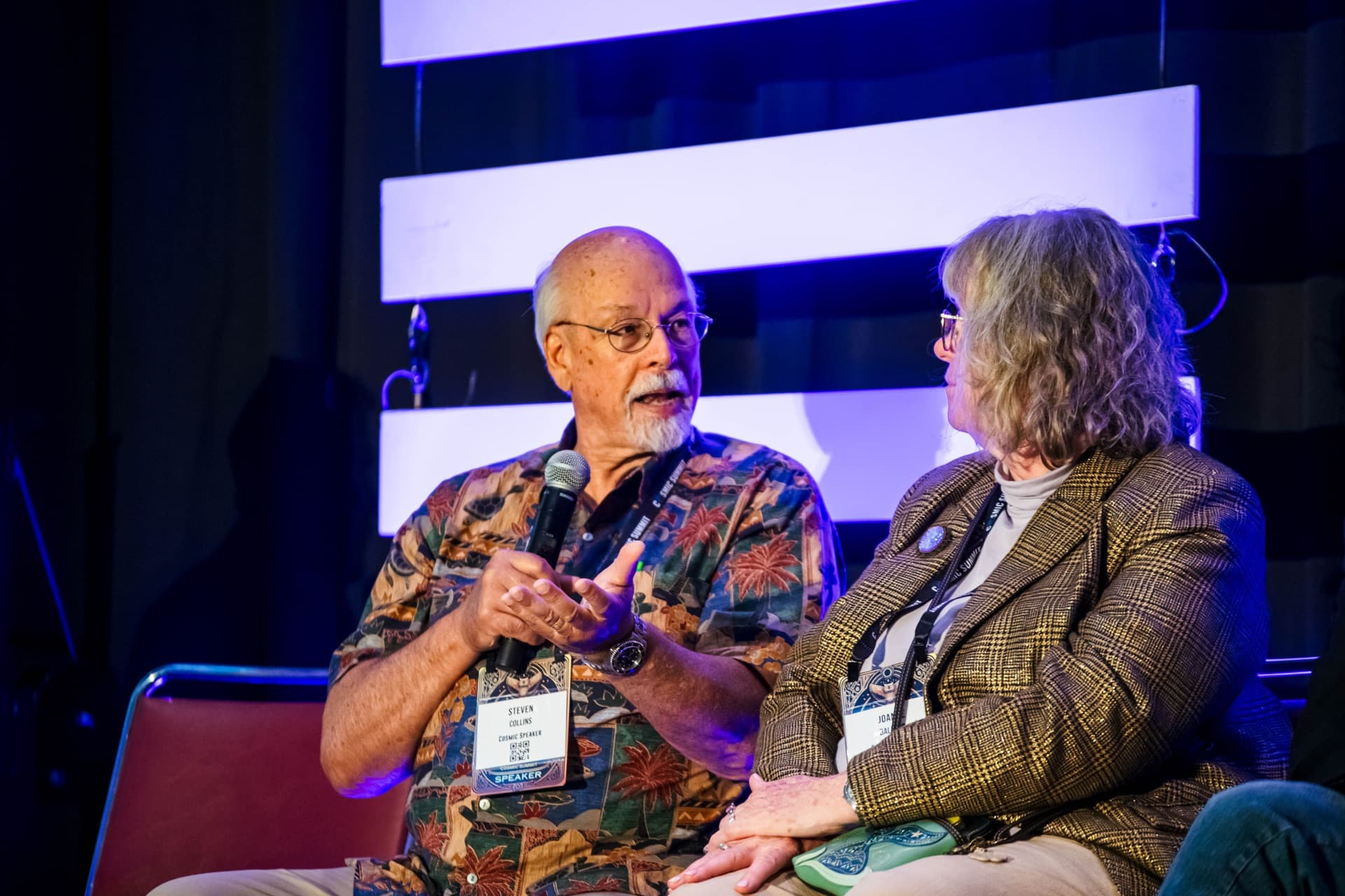 Two Cosmic Summit speakers in panel discussion, mid-conversation